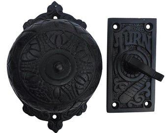 May include: Black metal doorbell with a decorative design and a push button labeled "TURN".