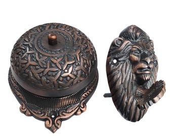 May include: Antique brass door bell with a lion head design. The bell is round and has a decorative pattern. The lion head is detailed and has a realistic expression.