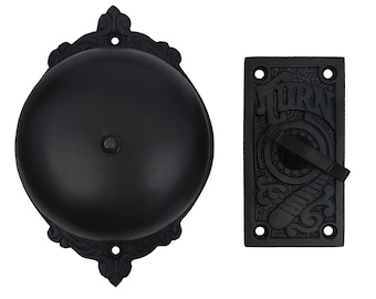 May include: Black cast iron doorbell with a decorative design and the word "TURN" on the button.