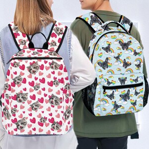 May include: Two backpacks with different designs. One backpack is white with pink hearts and a cat face pattern. The other backpack is light blue with a rainbow and dog face pattern.