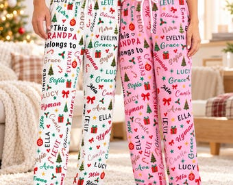 May include: Two pairs of pajama pants, one white and one pink, featuring a repeating pattern of Christmas trees, red bows, ornaments, gifts, and the text "This GRANDPA belongs to" followed by various names in different colors and fonts.