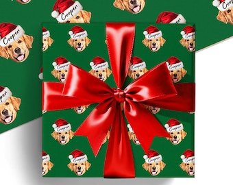 May include: Green wrapping paper featuring a repeating pattern of golden retriever faces wearing Santa hats, each labeled "Cooper." A large red satin bow adorns the wrapped gift, creating a festive holiday presentation.
