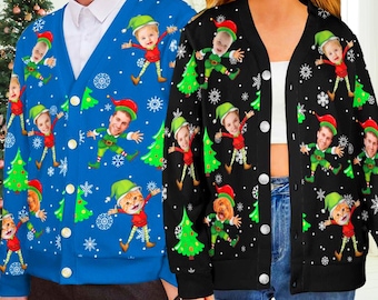 May include: A blue cardigan and a black cardigan, both featuring a repeating pattern of Christmas trees, snowflakes, and cartoon elves with human faces and a cat face. Each cardigan has a V-neckline, long sleeves, and a front button closure.