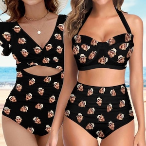 May include: Two black swimsuits with a pattern of a person's face. The swimsuit on the left is a one-piece with a cut-out at the waist. The swimsuit on the right is a bikini with a halter top and high-waisted bottoms.