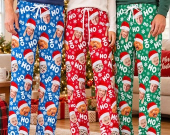 May include: Three pairs of lounge pants featuring a repeating pattern of faces wearing Santa hats, snowflakes, and the text HO HO HO. The pants are blue, red, and green, each with a white drawstring at the waist and a straight-leg fit.