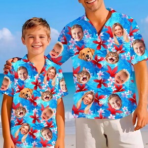 May include: Two matching blue Hawaiian shirts with a custom design. The shirts feature a vibrant pattern of faces, flowers, and leaves. The shirts are short-sleeved and have a button-down front. The background is a beach scene.