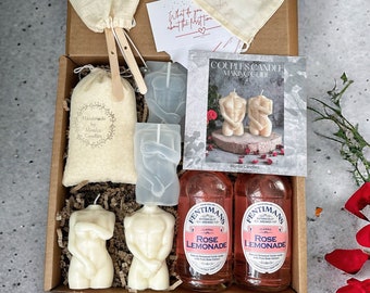 May include: A gift box set for couples includes two clear silicone molds shaped like a man and woman's torso, two white candles in the shape of a man and woman's torso, a small bag of white wax, two wooden stirring sticks, a small bag of white wax, a small bag of white wax, two bottles of pink rose lemonade, and a booklet titled "Couples Candle Making Guide".