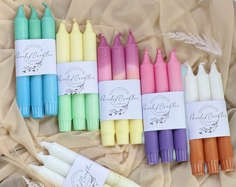 May include: A set of 10 hand-dipped candles in various colors, including light blue, yellow, green, pink, purple, white, and orange. Each set of three candles is wrapped in a label that reads "Hand Dipped in London" and "Honeyleaf Candles".