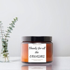 May include: A brown glass candle jar with a black lid. The label reads "Thanks for all the ORGASMS" and "Scented Soy Wax Hand Poured in London".