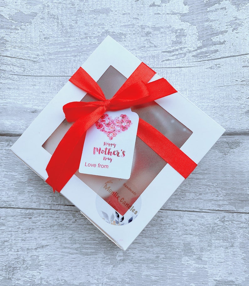 May include: White gift box with a red ribbon and a tag that says "Happy Mother's Day Love from" and a sticker that says "Handmade Monlix Candles".