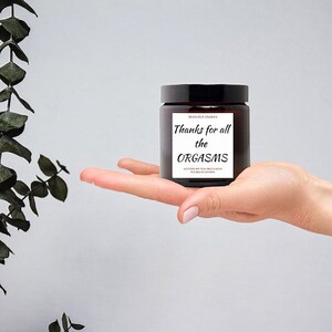 May include: A brown glass candle jar with a white label that reads "Thanks for all the ORGASMS".