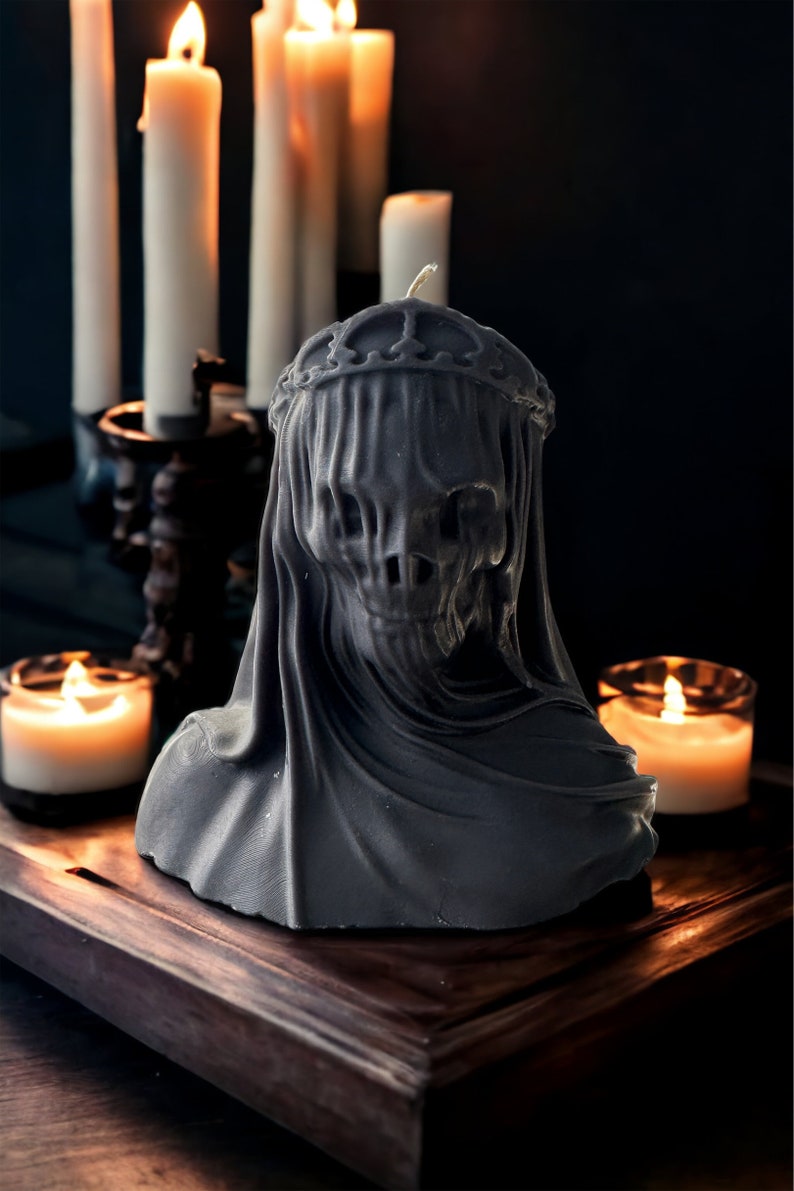 May include: A black candle in the shape of a hooded figure with a crown. The candle is surrounded by other candles.