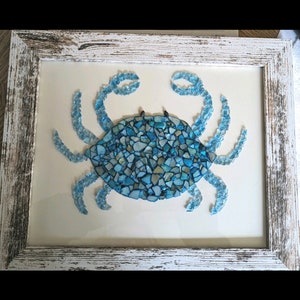 May include: A blue crab made of mosaic glass tiles, framed in a whitewashed wood frame.