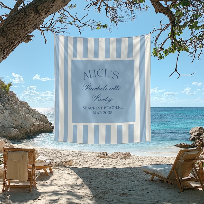 May include: A blue and white striped beach towel with the text "Alice's Bachelorette Party Seacrest Beach FL MAR 2025" printed on it. The towel is hanging on a tree branch over a beach with two lounge chairs.