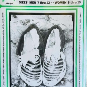 May include: A printed instructional document titled PLAINS INDIAN MOCCASIN PATTERN PM/80. It features a black and white photograph of a pair of moccasins with striped uppers and dark cuffs. Text indicates sizes for men 7 thru 12 and women 5 thru 10.