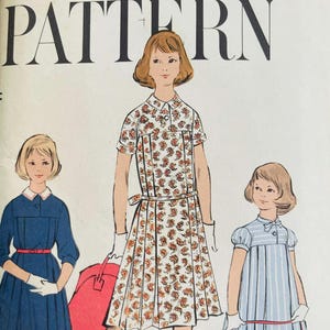 May include: Vintage Vogue printed pattern featuring illustrations of three dresses. The dresses include a blue dress with a white collar, a paisley print dress, and a blue and white striped dress. The pattern is for children's clothing.