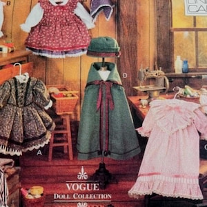 May include: A display of vintage doll clothes, including dresses, a cape, and a hat. The clothes are in various colors and patterns, with lace and ribbon details. The Vogue Doll Collection logo is visible.