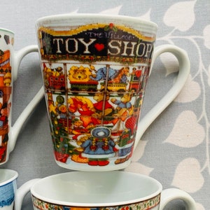 May include: A set of four white ceramic mugs with colorful holiday designs. The mugs feature a toy shop, a winter scene, a bird, and a snowman. The mugs have a handle on the right side.