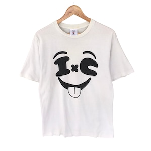 May include: White t-shirt with a black and white smiley face graphic featuring the text "I*C".