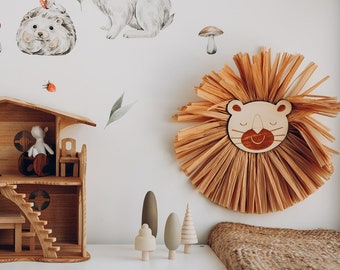 May include: A white shelf unit with two wicker baskets, a wooden dollhouse, and a stuffed animal. The wall behind the shelf is decorated with animal stickers, including a fox, a rabbit, an owl, and a hedgehog.