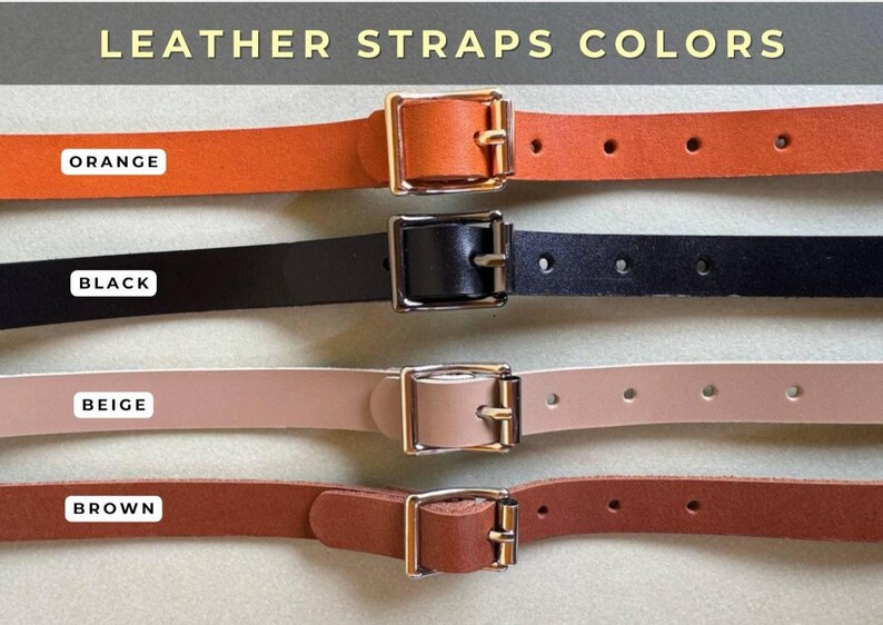 May include: Four leather straps in different colors: orange, black, beige, and brown. Each strap has a gold metal buckle and is shown against a light beige background.