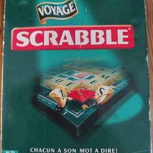 May include: A green Scrabble Voyage board game box featuring the Mattel Jeux logo, the word Voyage, and the Scrabble logo in red. The box displays a game board illustration with letter tiles and the French text Chacun a son mot a dire.
