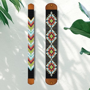 May include: Two beaded wall hangings with geometric patterns. The left hanging features a chevron pattern in shades of red, orange, yellow, blue, and green. The right hanging features a repeating diamond pattern in shades of red, orange, yellow, blue, and green. Both hangings have brown leather straps at the top and bottom.
