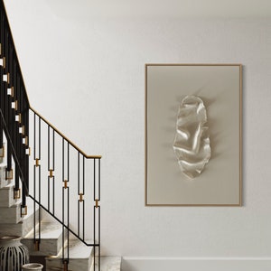 May include: A white wall with a modern staircase with black metal railings and gold accents. A framed artwork with a white textured design hangs on the wall.