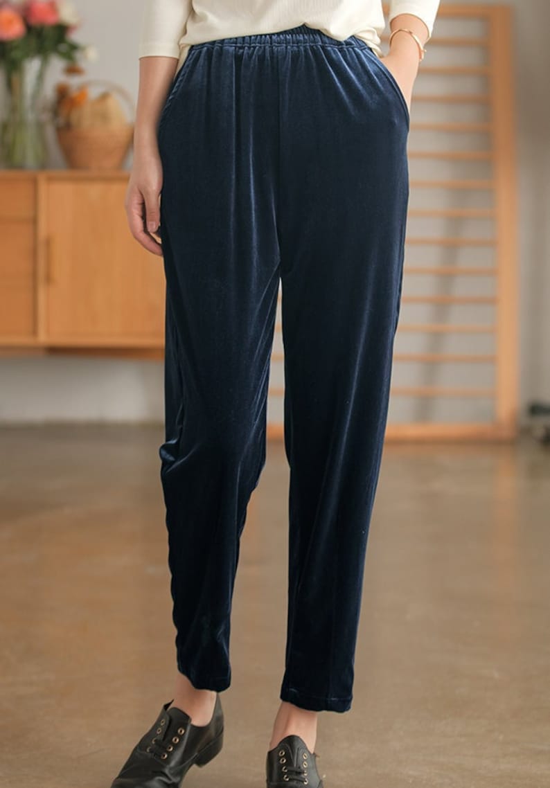 May include: Dark blue velvet pants with an elastic waistband and side pockets.