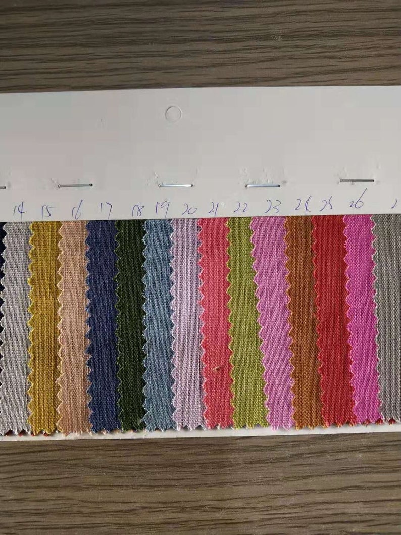 May include: Swatch card with 14 fabric samples in various colors, including beige, blue, green, gray, pink, red, and brown. The samples are numbered 14 through 27.