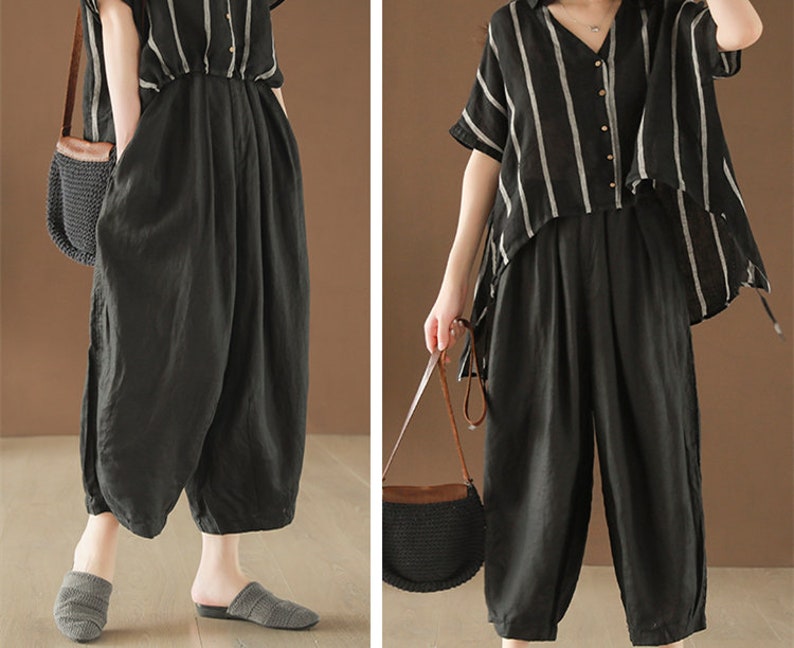 May include: A black and white striped linen shirt with a black linen pair of wide-leg pants. The shirt has a V-neck and a button-up front. The pants have a high waist and a relaxed fit.