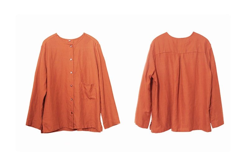 May include: A long-sleeved, button-up shirt in a burnt orange colour. The shirt has a simple design with a single pocket on the left side.