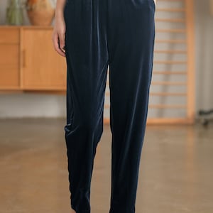 May include: Navy blue velvet pants with an elastic waistband and side pockets.