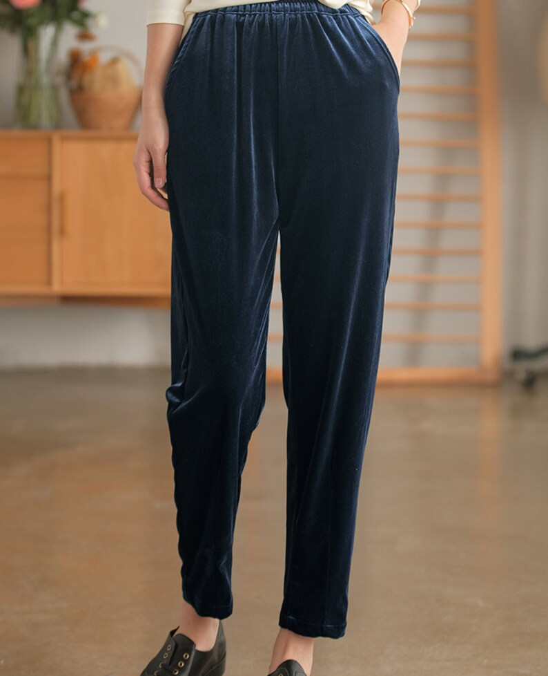 May include: Navy blue velvet pants with an elastic waistband and side pockets.