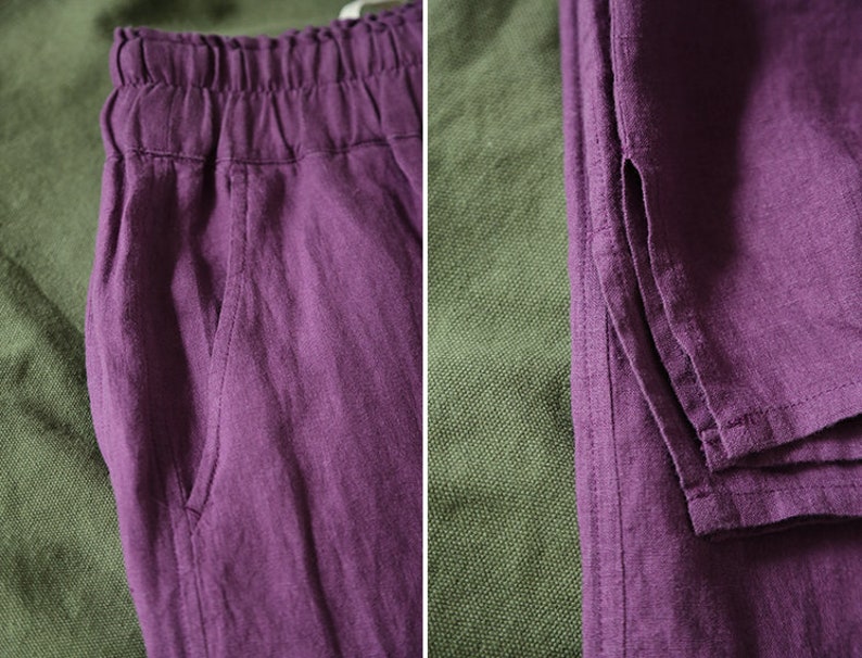 May include: A pair of purple linen pants with a drawstring waist and side pockets. The pants are folded and laid out on a green fabric background.