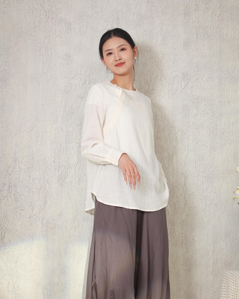 May include: A set of three ceramic nesting bowls in graduating sizes. The bowls feature a speckled, matte finish in shades of cream, light brown, and dark brown. The largest bowl measures approximately 8 inches in diameter.