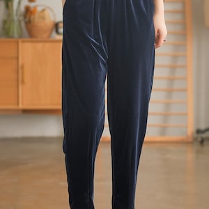 May include: Dark blue velvet pants with an elastic waistband and side pockets.