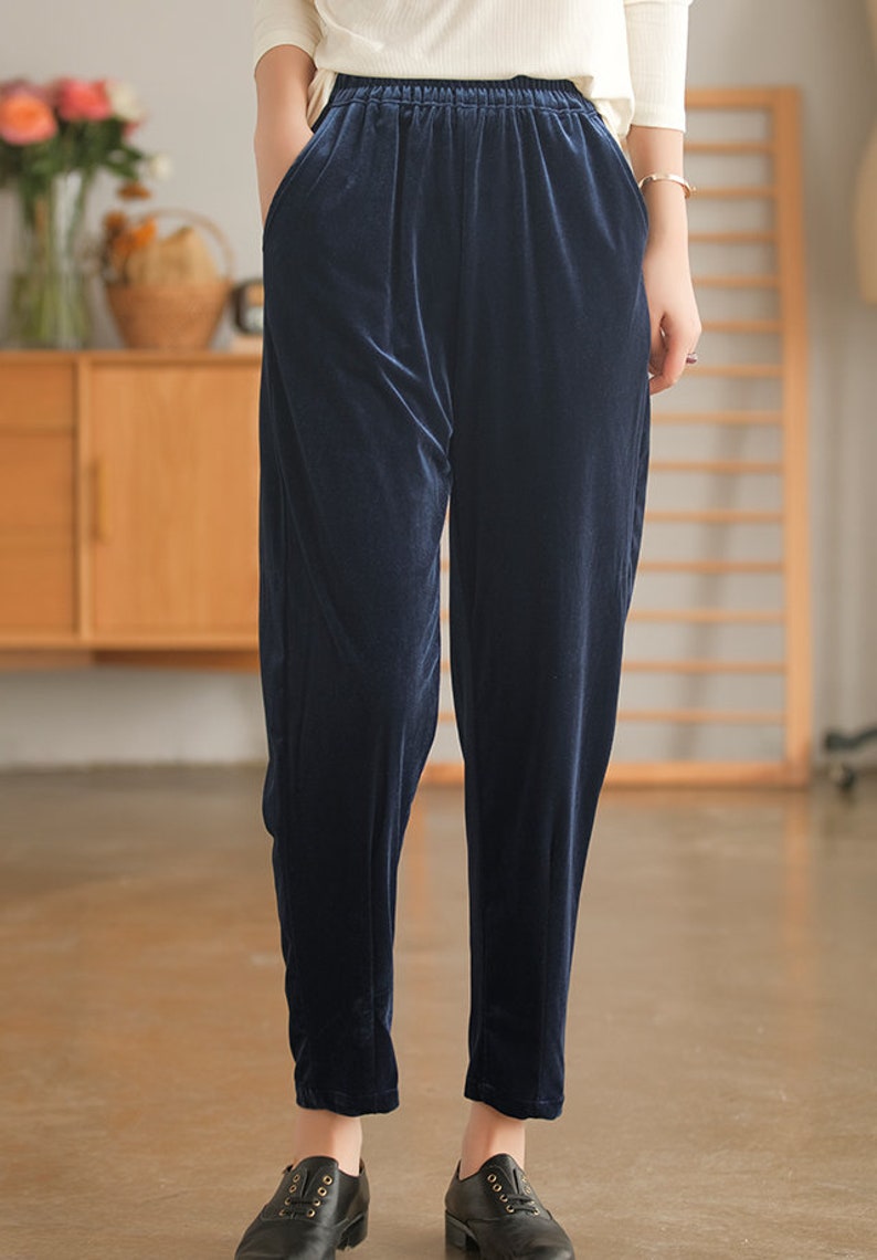 May include: Dark blue velvet pants with an elastic waistband and side pockets.