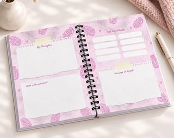 May include: A spiral-bound journal with a light purple background featuring a pattern of small pink hand grenades and hearts. The pages include sections labeled My Thoughts, What is the solution, Feel Good Music, and Message to Myself with white boxes.