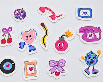 May include: A collection of die-cut stickers featuring a disco ball, a pink telephone handset, a blue envelope with a heart, cherries with a bow, a heart on roller skates, a wavy yellow pencil, a pink bomb, a rotary phone, a vinyl record, a heart stamp, a bow, and a disco ball character.