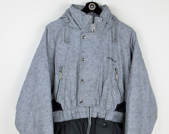 May include: A grey and black ski jacket with a drawstring waist and a zip closure. The jacket has a hood and a logo that says "O'Neill" on the front.
