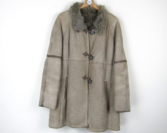 May include: A long, brown sheepskin coat with a fur collar and brown toggle closures.