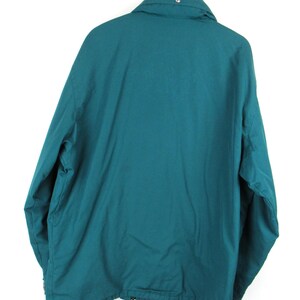 May include: A teal blue jacket with a zipper and a drawstring at the bottom.