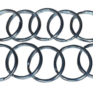 May include: Ten silver key rings, arranged in two rows of five. The key rings are all the same size and shape, and they are made of a shiny metal.