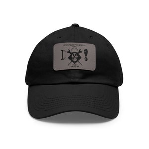 May include: Black baseball cap with a gray patch featuring a skull and crossbones design. The patch reads "Ironworkers Pro" and "To Get High".