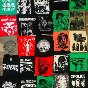 May include: A selection of band t-shirts, showcasing designs for various rock and punk bands. The shirts are in different colours, with graphics and band names including "The Smiths", "The Damned", and "The Police".