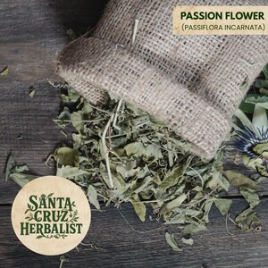 May include: A hessian sack spilling dried passion flower leaves, with the text "PASSION FLOWER (PASSIFLORA INCARNATA)". A round logo for Santa Cruz Herbalist is in the lower left corner. The background is a dark wooden surface.