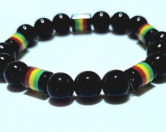 Pulsera de cuentas negras con detalles en rojo, amarillo y verde / Pulsera elástica para hombre y mujer / Joyería de inspiración rasta / Regalo unisex