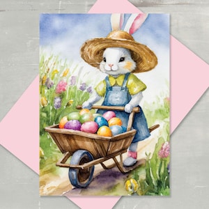 May include: Watercolor illustration of an Easter bunny pushing a wooden wheelbarrow filled with colorful Easter eggs. The bunny wears a straw hat, yellow shirt, and blue overalls. The background features a field of flowers and a blue sky.