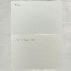 May include: Close-up of two white paper samples. The top sample is labeled "Cotton". The bottom sample is labeled "Watercolor Paper Texture".